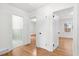 Hardwood floor hallway with access to bedrooms and bath at 303 Forest Rd, Oxford, NC 27565