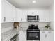 Stainless steel kitchen appliances and white shaker cabinets at 303 Forest Rd, Oxford, NC 27565