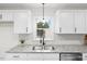 Modern kitchen sink with granite countertop and white cabinets at 303 Forest Rd, Oxford, NC 27565