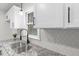 Modern kitchen sink with granite countertop and white cabinets at 303 Forest Rd, Oxford, NC 27565