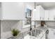 Modern kitchen sink with granite countertop and white cabinets at 303 Forest Rd, Oxford, NC 27565