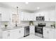 Updated kitchen with white shaker cabinets and stainless steel appliances at 303 Forest Rd, Oxford, NC 27565