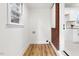 Laundry room with brick accent wall and vinyl flooring at 303 Forest Rd, Oxford, NC 27565