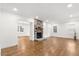Spacious living room with hardwood floors and a stone fireplace at 303 Forest Rd, Oxford, NC 27565