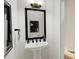 Modern powder room with pedestal sink and sleek black accents at 4041 Elk Creek Ln # 16, Raleigh, NC 27612