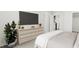 Bright bedroom with TV and dresser at 4041 Elk Creek Ln # 16, Raleigh, NC 27612
