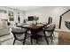 Modern dining room with wood table, gray chairs, and access to living room at 4041 Elk Creek Ln # 16, Raleigh, NC 27612