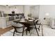 Dining area features a wood table and modern chairs near the kitchen at 4041 Elk Creek Ln # 16, Raleigh, NC 27612