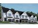 Modern three-story townhouses with attached garages and landscaped yards at 4041 Elk Creek Ln # 16, Raleigh, NC 27612