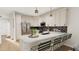 L shaped kitchen with breakfast bar, stainless steel appliances, and marble counters at 4041 Elk Creek Ln # 16, Raleigh, NC 27612