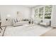 Living room features light colored sofa and chairs near large windows at 4041 Elk Creek Ln # 16, Raleigh, NC 27612