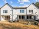 Rear view of three-unit building, showing patios and AC units at 507 Excelsior Ct, Rolesville, NC 27587