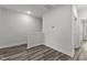 Bright hallway with wood-look flooring and access to bedrooms at 507 Excelsior Ct, Rolesville, NC 27587
