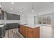 Open concept kitchen with island, stainless steel appliances, and sliding glass doors at 507 Excelsior Ct, Rolesville, NC 27587