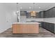 Modern kitchen with gray cabinetry, large island, and white countertops at 507 Excelsior Ct, Rolesville, NC 27587