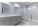 Modern bathroom with double vanity, large shower, and gray cabinets at 509 Excelsior Ct, Rolesville, NC 27587