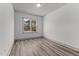 Simple bedroom with large window and wood flooring at 509 Excelsior Ct, Rolesville, NC 27587