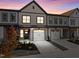 Modern townhome with two-car garage and landscaped front yard at 509 Excelsior Ct, Rolesville, NC 27587