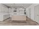 Modern kitchen with island, stainless steel appliances, and light cabinets at 509 Excelsior Ct, Rolesville, NC 27587