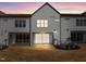 Evening view of three-unit building, highlighting rear patio at 509 Excelsior Ct, Rolesville, NC 27587