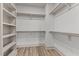 Large walk-in closet with shelves and hanging rods at 509 Excelsior Ct, Rolesville, NC 27587