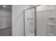 Clean shower with glass enclosure and built-in shelving at 929 Canis Minor Rd, Wendell, NC 27591