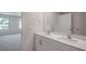 Modern bathroom with double vanity and a view into a bedroom at 933 Canis Minor Rd, Wendell, NC 27591