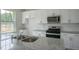 Modern kitchen with white cabinets, granite countertops and stainless steel appliances at 933 Canis Minor Rd, Wendell, NC 27591