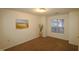Spacious bedroom with large window and wall art at 11321 Involute Pl # 102, Raleigh, NC 27617