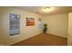 Bright bedroom with carpet and two windows at 11321 Involute Pl # 102, Raleigh, NC 27617