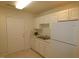 White kitchen with appliances and double sink at 11321 Involute Pl # 102, Raleigh, NC 27617