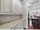 White kitchen cabinets with granite countertops and butlers pantry at 11350 Oakcroft Dr, Raleigh, NC 27614