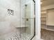 Walk-in shower with pebble floor and glass enclosure at 289 Hampshire Ct, Four Oaks, NC 27524