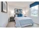 Bright bedroom with a full-size bed and blue and white bedding at 481 Autumn Moon Dr, Zebulon, NC 27597