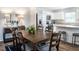 Dining area with dark brown table and chairs, adjacent to the kitchen at 481 Autumn Moon Dr, Zebulon, NC 27597