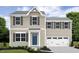 Two-story house with beige siding, a blue door, and a white three-car garage at 481 Autumn Moon Dr, Zebulon, NC 27597
