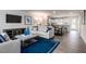 Open living space with light-colored sofa and blue accents at 481 Autumn Moon Dr, Zebulon, NC 27597
