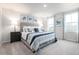 Spacious main bedroom with a king-size bed and gray upholstered headboard at 481 Autumn Moon Dr, Zebulon, NC 27597