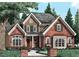Brick two-story home with a classic design and landscaped front yard at 6464 Guess Rd, Durham, NC 27712