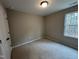 Bright bedroom with carpeted floor, large window, and neutral walls at 826 Roberts Rd, Sanford, NC 27332