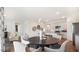 Open concept dining area with a dark wood table and four light gray chairs at 97 Ethel Ln, Angier, NC 27501