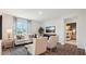 Bright living room with hardwood floors, comfy seating, and a view into a bedroom at 97 Ethel Ln, Angier, NC 27501