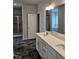 Double vanity bathroom with dark tile floors at 115 Lemon Drop Ln, Franklinton, NC 27525