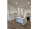 Modern kitchen with white cabinets and a large island at 115 Lemon Drop Ln, Franklinton, NC 27525