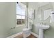 Powder room with pedestal sink and window at 1235 Shaw View Alley # 201, Raleigh, NC 27601