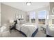 Charming bedroom with large windows and a blue upholstered bed at 1235 Shaw View Alley # 201, Raleigh, NC 27601