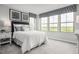 Bright bedroom with white bedding and large windows at 1404 Rollman Farm Rd, Garner, NC 27603