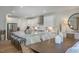 Spacious dining room adjacent to kitchen with wood table and neutral decor at 166 Blue Butterfly Dr, Angier, NC 27501