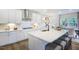 Bright kitchen with island, white cabinets, and stainless steel appliances at 166 Blue Butterfly Dr, Angier, NC 27501