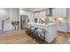 Kitchen with island, white cabinets, and stainless steel appliances at 166 Blue Butterfly Dr, Angier, NC 27501